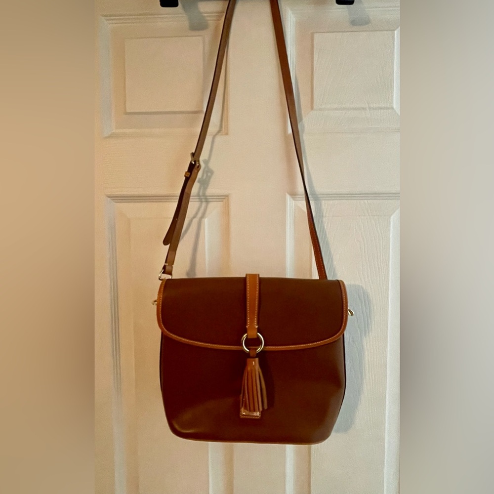 Dooney & Bourke Leather Bag.Foldover flap with snap Red lined interior.